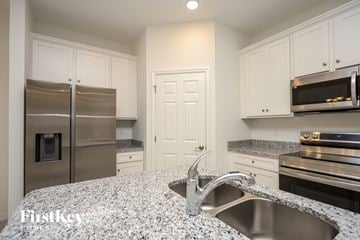 Bartow house for rent - a kitchen with granite counter tops and stainless steel appliances