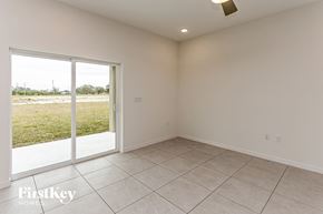 Bartow house for rent - A room with a sliding glass door leading to a grassy area.
