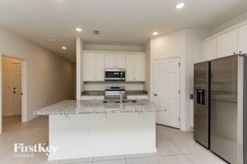Bartow house for rent - A kitchen with granite countertops and stainless steel appliances.