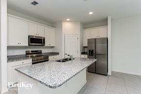 Bartow house for rent - A kitchen with granite countertops and stainless steel appliances.