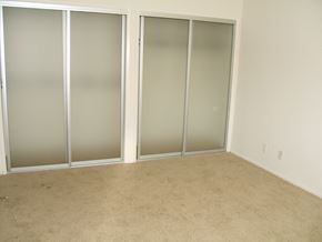Los Angeles apartment for rent - A room with a carpeted floor and three glass doors.