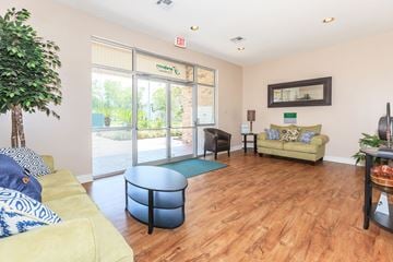 Thibodaux townhouse for rent - a living room with furniture and sliding glass doors to a pool