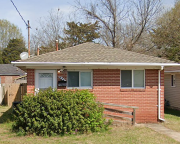 Hampton house for rent - A small red brick house with a white door and windows.