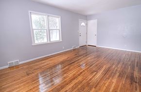 Grand Forks house for rent - A room with a wooden floor and a white door.