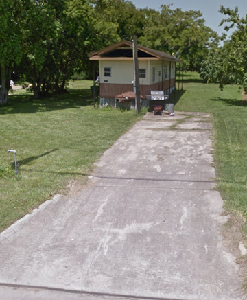 El Campo house for rent - A concrete pathway leads to a small house.
