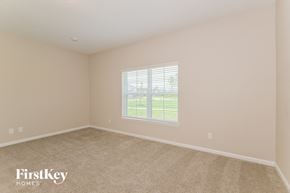 Yulee house for rent - a bedroom with a large window and a carpeted floor