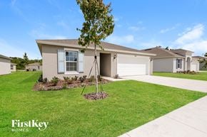 Winter Haven house for rent - a beige house with a tree in the front yard