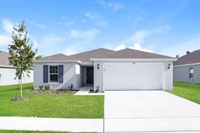 Winter Haven house for rent - a white house with a garage door and a lawn
