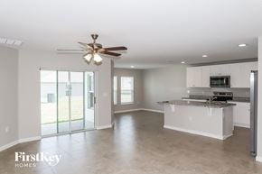 Winter Haven house for rent - an empty kitchen and living room with a ceiling fan