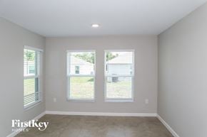 Winter Haven house for rent - a living room with three windows and a cement floor