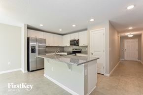 Winter Haven house for rent - a kitchen with an island and a stainless steel refrigerator