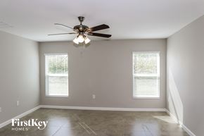 Winter Haven house for rent - A room with a ceiling fan and two windows.