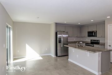 Winter Haven house for rent - A kitchen with a granite countertop and stainless steel appliances.