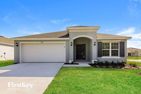 Winter Haven house for rent - A house with a garage door and a driveway in front.