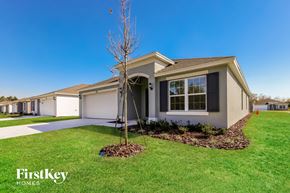 Winter Haven house for rent - A house with a bare tree in front of it.