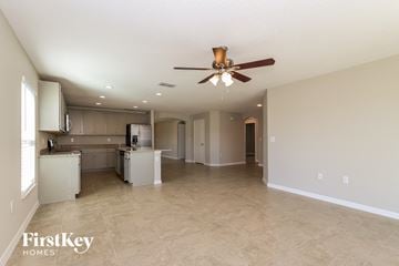 Winter Haven house for rent - A spacious kitchen and living room with a ceiling fan.