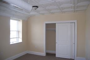 Suffolk apartment for rent - a bedroom with a closet and a window and a white door