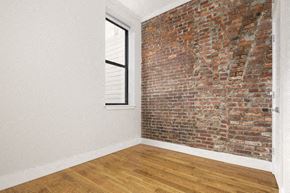 New York apartment for rent - an exposed brick wall in an empty room with a window