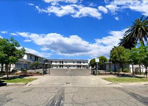Merced house for rent - A large open area with a building in the background and a palm tree on the right.