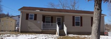 Olive Hill house for rent - a tan house with red shutters and a white porch
