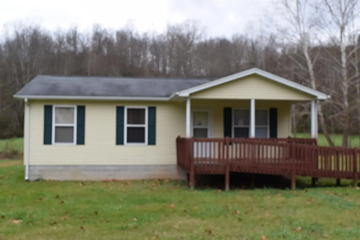 Olive Hill house for rent - a small yellow house with a porch and a wooden deck