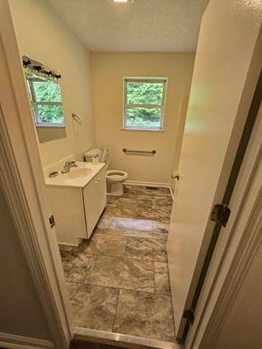 Morehead house for rent - a bathroom with a toilet and a sink and a window