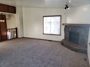 Eagle River apartment for rent - A living room with a fireplace and a window.