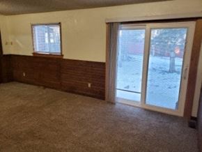Eagle River apartment for rent - A room with a carpeted floor and a sliding glass door.