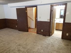 Eagle River apartment for rent - A room with carpeted floor and three doors.