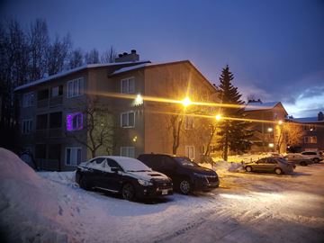 Anchorage apartment for rent - A black car is parked in a snow-covered parking lot.