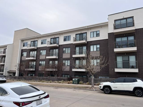 Plano house for rent - an apartment building with cars parked in front of it