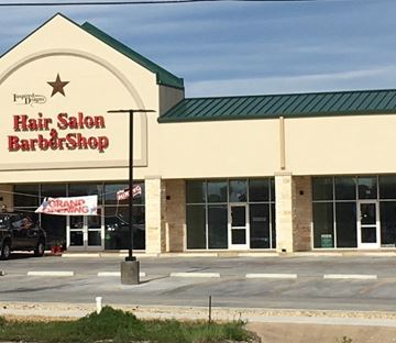 Killeen apartment for rent - the front of a hair salon barber shop with a car parked outside