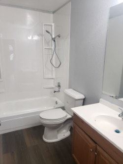 Anchorage apartment for rent - A white toilet sits next to a white sink in a small bathroom.