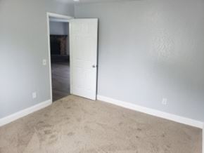 Anchorage apartment for rent - A room with a white door and carpet.