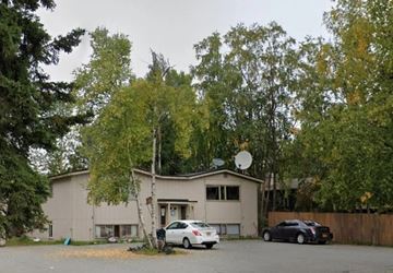 Anchorage apartment for rent - a house with a car parked in front of it