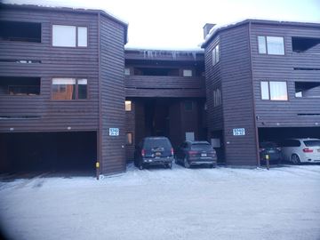 Anchorage apartment for rent - A parking garage with cars parked in it.