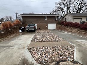 Omaha apartment for rent - a driveway with rocks and gravel in front of a house