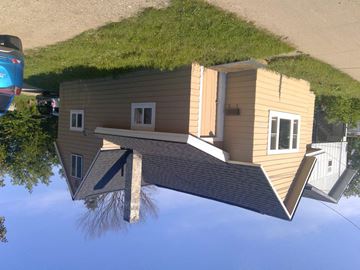 Boyne City house for rent - a reflection of a house with a grassy roof