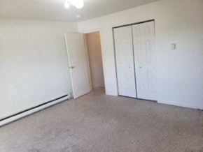 Anchorage apartment for rent - A white wall with a brown door and a white cabinet.