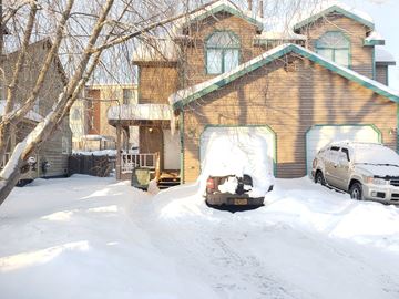 Anchorage apartment for rent - a house with a car parked in the snow