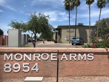 Peoria apartment for rent - A sign that says Monroe Arms 8954 in front of a building.