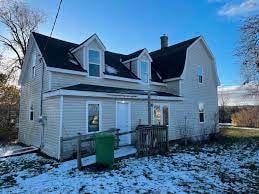 Westville apartment for rent - A white house with a green trash can in front.