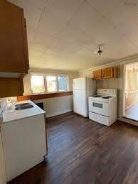 Westville apartment for rent - A kitchen with white appliances and wooden cabinets.