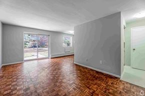 Brampton apartment for rent - A room with a wooden floor and sliding glass doors.