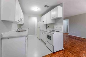Brampton apartment for rent - A kitchen with white appliances and cabinets.