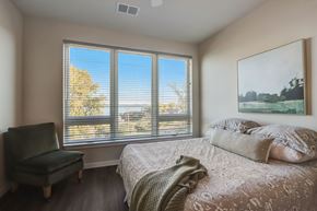 Middleton apartment for rent - the master bedroom has a large window and a bed with pillows