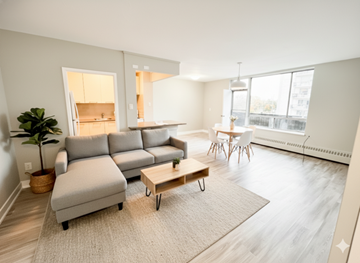 Mississauga apartment for rent - A living room with a grey sofa and a wooden coffee table.