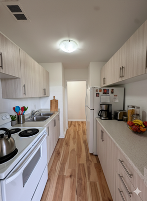 Mississauga apartment for rent - A kitchen with white appliances and wooden floors.