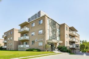Mississauga apartment for rent - A large apartment building with the name "Praveen" on the front.