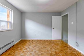 Brampton apartment for rent - A room with a wooden floor and a window.